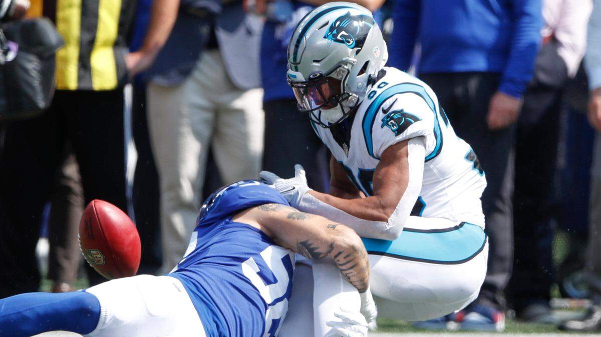 Carolina Panthers’ Chuba Hubbard, right, fumbles the ball during the first half an NFL football game against the New York Giants, Sunday, Sept. 18, 2022, in East Rutherford, N.J. (AP Photo/Noah K. Murray)