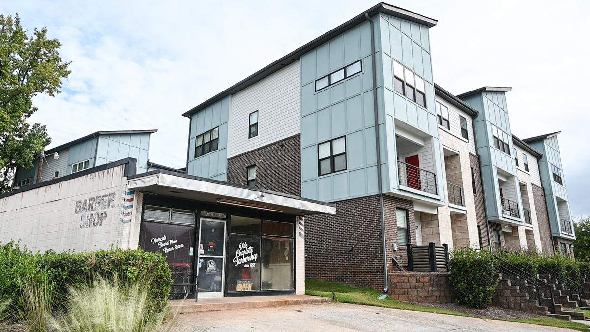 Olde Charlotte Barber Shop sits next to a brand new apartment complex on Central Avenue in Plaza Midwood.