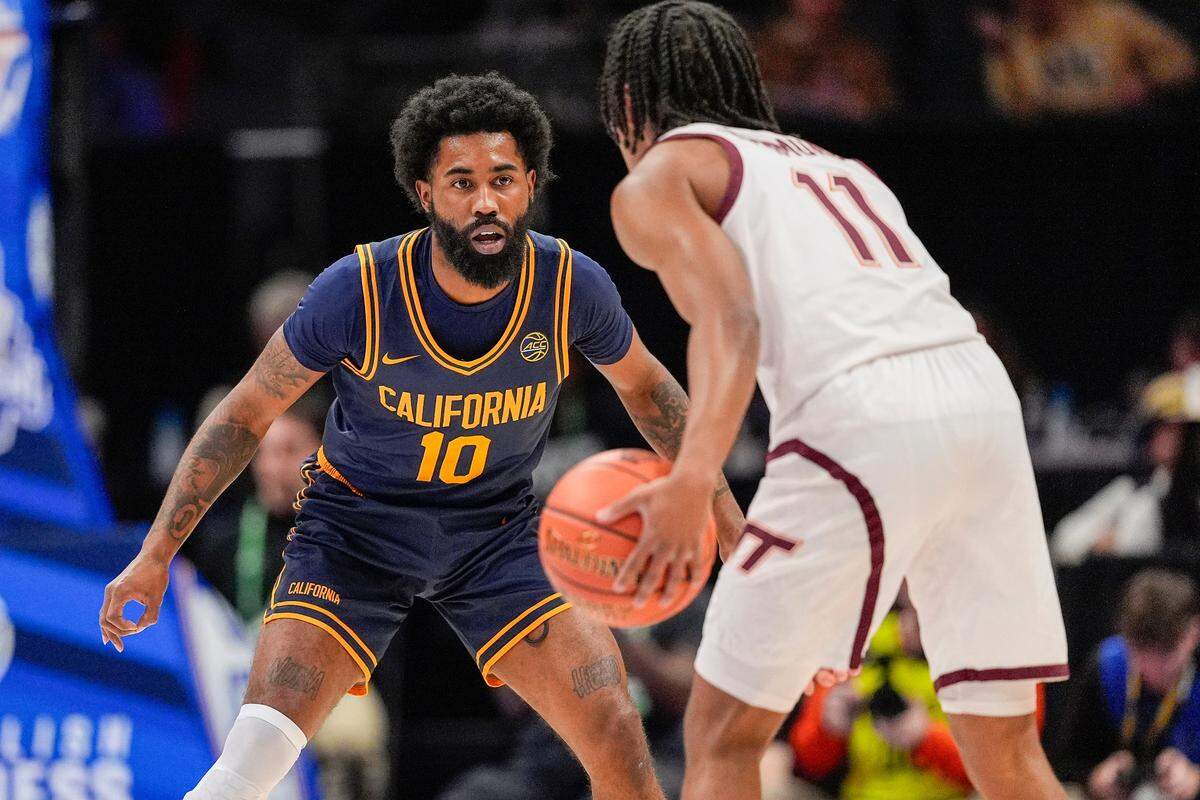 Mar 11, 2025; Charlotte, NC, USA; California Golden Bears guard Jovan Blacksher Jr. (10) on defense against Virginia Tech Hokies guard Ben Hammond (11) during the first half at Spectrum Center. Mandatory Credit: Jim Dedmon-Imagn Images