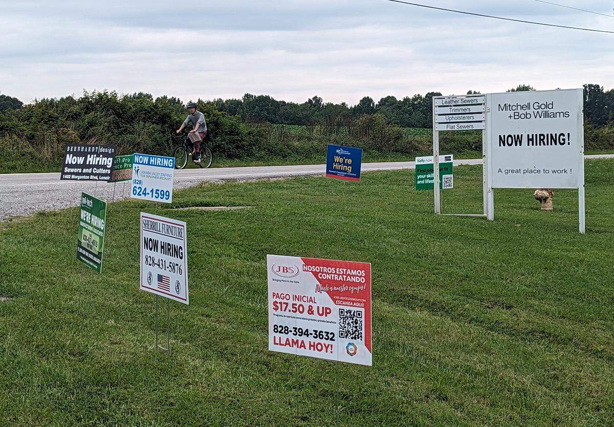 Jacob Ramirez, a former employee at Mitchell Gold + Bob Williams, rides by the Taylorsville facility’s entrance Aug. 30.