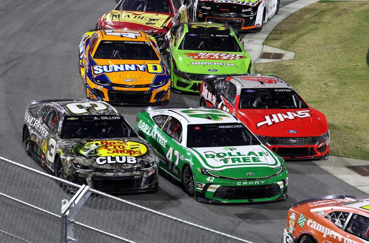 NASCAR Cup Series drivers Austin Dillon, left, John Nemecheck, center and Cole Custer, right, go three wide in Turn 1 during the NASCAR Cup Series Last Chance Race at Bowman Gray Stadium in Winston-Salem, NC on Sunday, February 2, 2025. Driver Kyle Larson won the race.