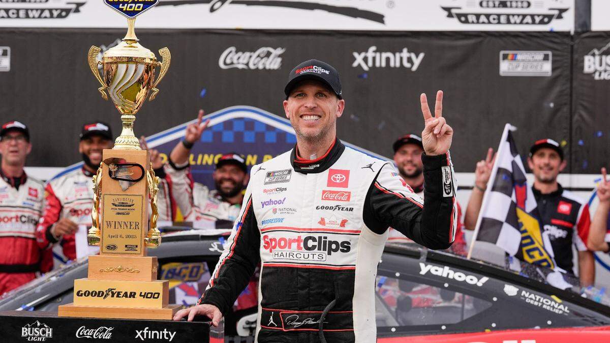 Apr 6, 2025; Darlington, South Carolina, USA; NASCAR Cup Series driver Denny Hamlin (11) and his crew celebrate the win during the Goodyear 400 at Darlington Raceway.