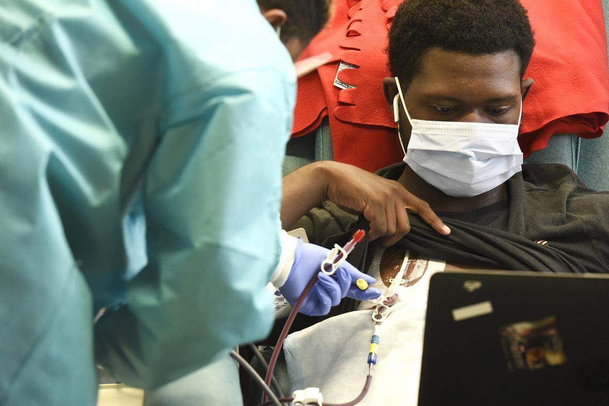 During treatment, a nurse connects a dialysis machine to the open catheter site near Isaac’s heart. He sits there for four hours as the dialyzer filters his blood, typically taking the time to complete homework.