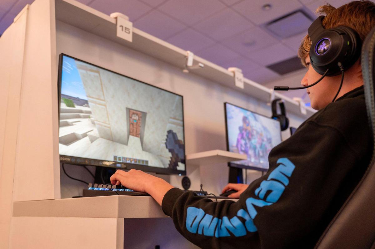 Traveler Callen McCoy plays Minecraft in the Gameway lounge. It offers a variety of gaming platforms such as PC, Playstation and XBox.
