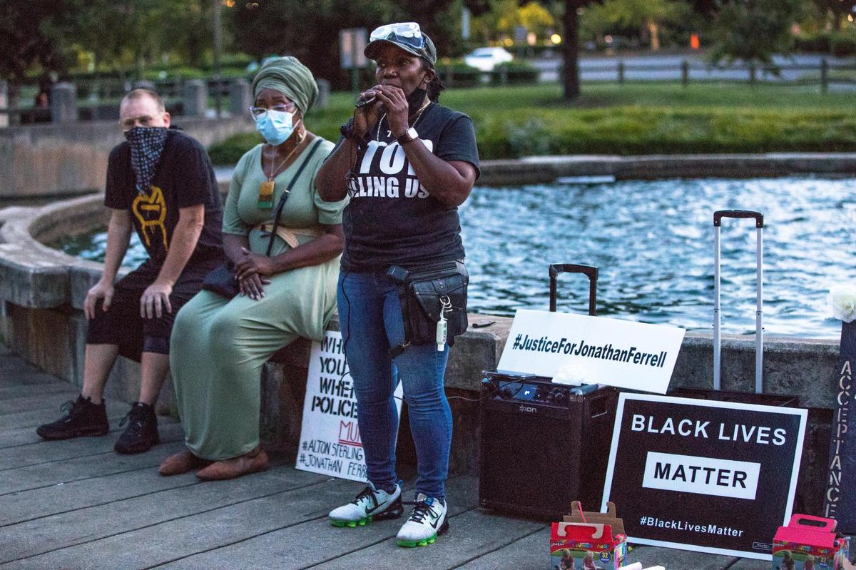 Kass Ottley, Founder of Seeking Justice CLT, spoke to a small crowd of a few dozen gathered at Marshall Park on Monday during a memorial service honoring Jonathan Ferrell, who was killed by CMPD on September 14, 2013.