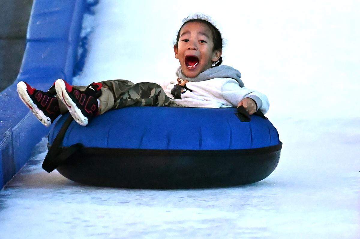 Lee Roy Thomas, 4, screams as he descends the 150-foot snow tubing hill at Truist Field in Charlotte on Wednesday, Nov. 22.