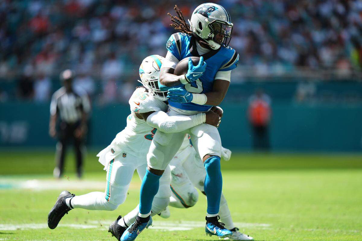 Oct 15, 2023; Miami Gardens, Florida, USA; Miami Dolphins linebacker Jerome Baker (55) tackles Carolina Panthers wide receiver Laviska Shenault Jr. (5) during the first half at Hard Rock Stadium. Mandatory Credit: Jasen Vinlove-USA TODAY Sports