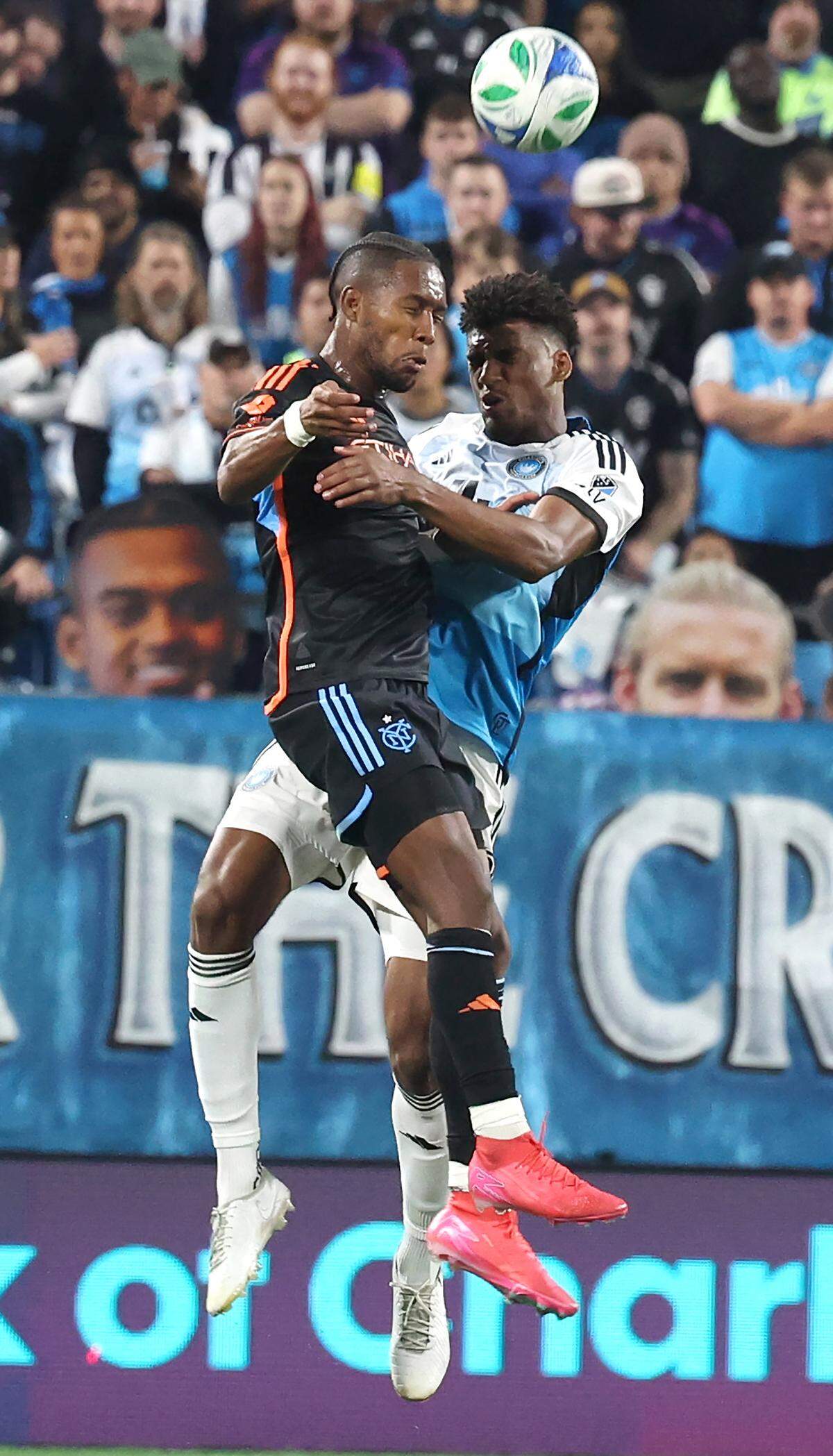 New York City FC defensive midfielder Andres Perea, left and Charlotte FC centre back Adilson Malanda, right, head a ball during action on Friday, November 7, 2025. The New York City FC defeated Charlotte FC 3-1 in Game 3 of the MLS Playoffs at Bank of America Stadium in Charlotte, NC.