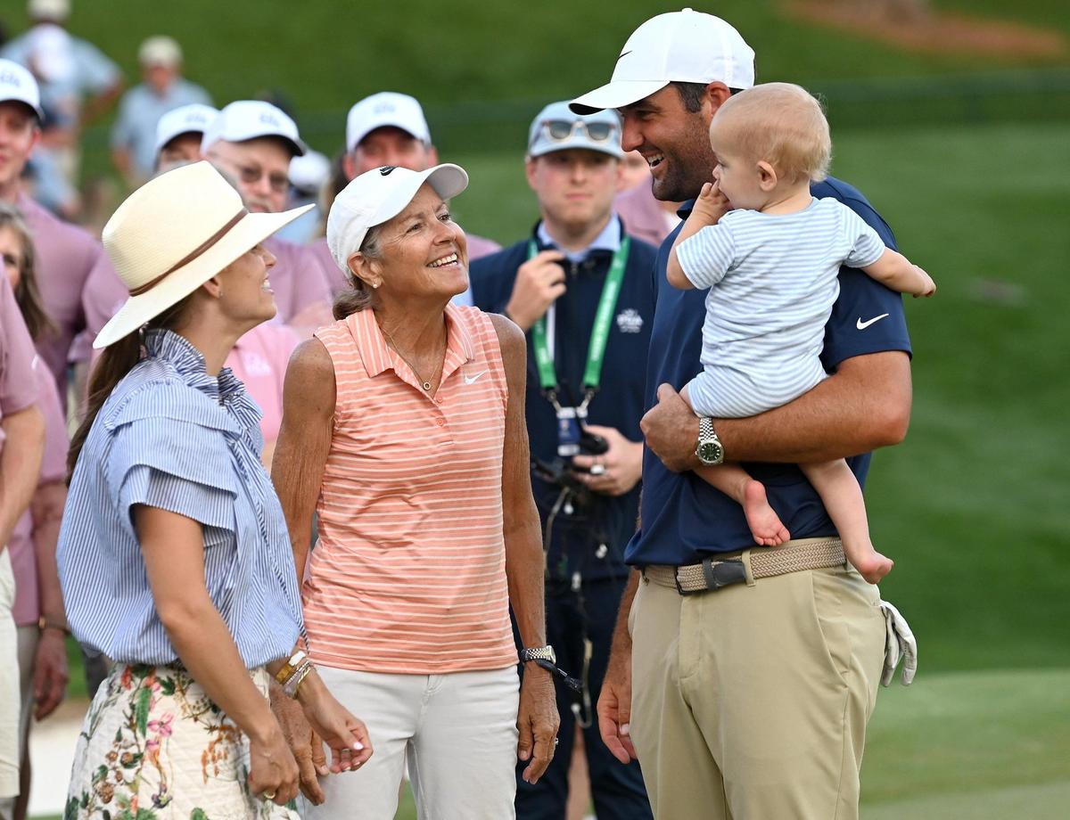 Scottie Scheffler (right) celebrates winning the PGA Championship with his family and his 1-year-old son Bennett at Quail Hollow Club in Charlotte on Sunday.