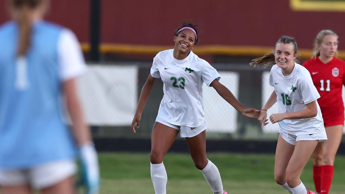 Myers Park’s Amaya Falzarano, center, smiles as she is congratulated by teammate Laine Connell, right, following a goal against South Meck during action on Tuesday, May 6, 2025.