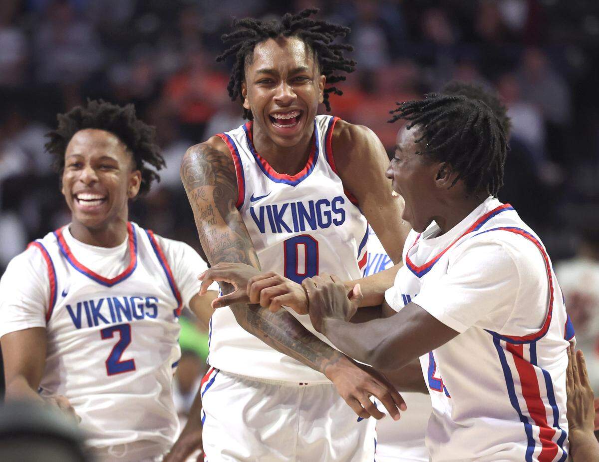 North Meck Vikings Isaiah Evans, center, celebrates the team’s 57-47 victory over New Hanover with his teammates on Saturday, March 16, 2024. The Vikings won the NCHSAA 4A State Championship at Lawrence Joel Veterans Memorial Coliseum in Winston-Salem, NC.