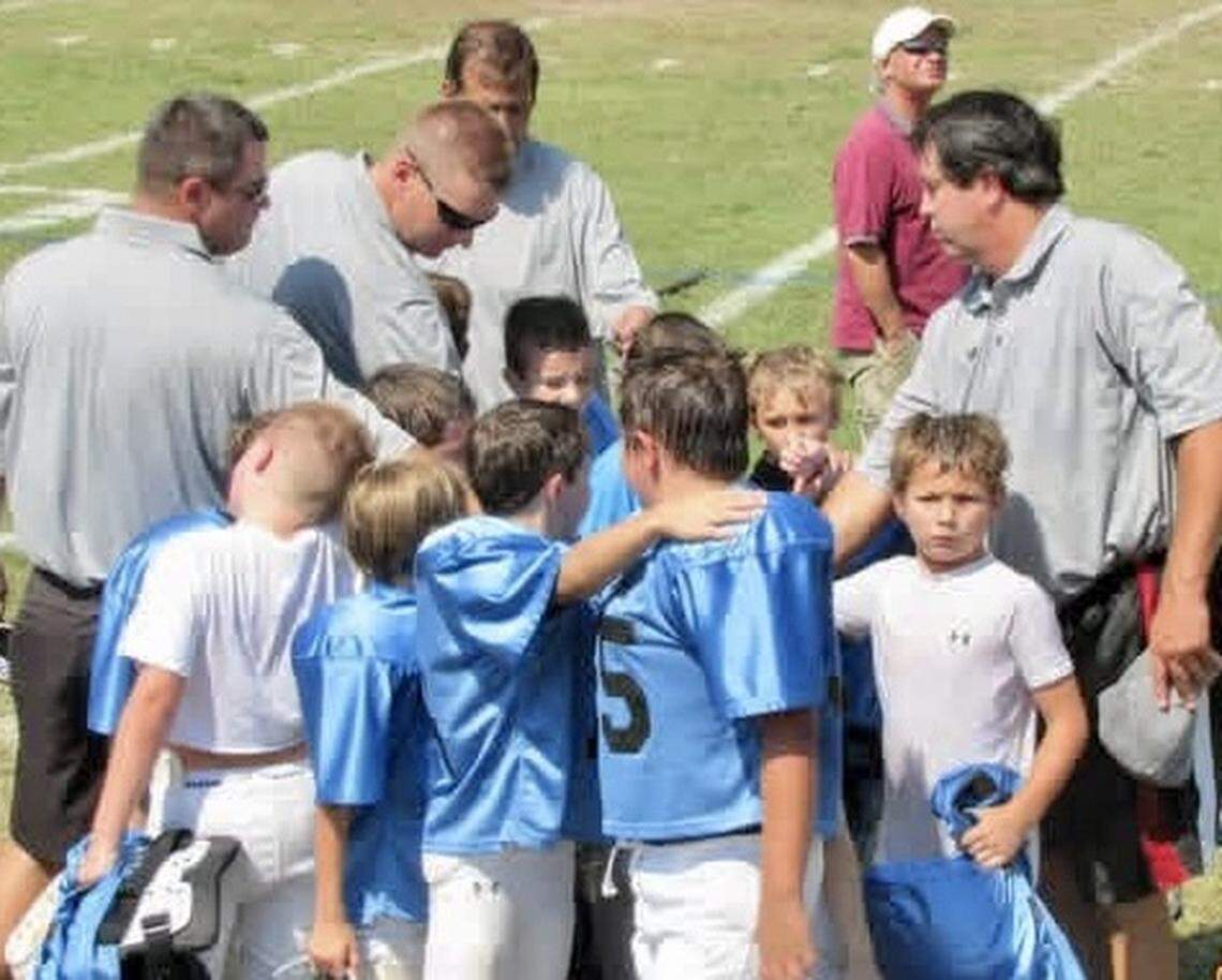 Drake Maye (in white T-shirt on far right, looking at camera) was smaller than most of his teammates when he began playing tackle football at age 8. His older brother Beau (to Drake’s left in the photo) was always the tallest player on the team.