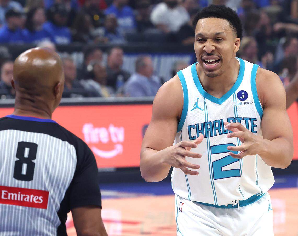 Charlotte Hornets forward Grant Williams, right, disputes a call with official Marc Davis, left, during action against the Orlando Magic at Kia Center in Orlando, FL on Friday, April 17, 2026.