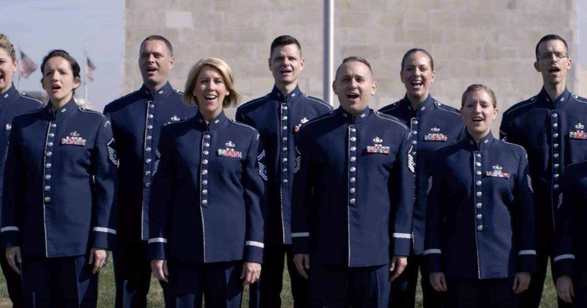 The Air Force “Singing Sergeants” sing the national anthem at the Washington Monument in 2017. Rob Harelson, who now performs with Opera Carolina, is in the center back row.