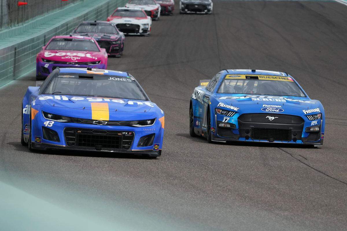 Oct 22, 2023; Homestead, Florida, USA; NASCAR Cup Series driver Erik Jones (43) and NASCAR Cup Series driver Chris Buescher (17) races into turn one during the 4EVER 400 presented by Mobil 1 at Homestead-Miami Speedway. Mandatory Credit: Jasen Vinlove-USA TODAY Sports