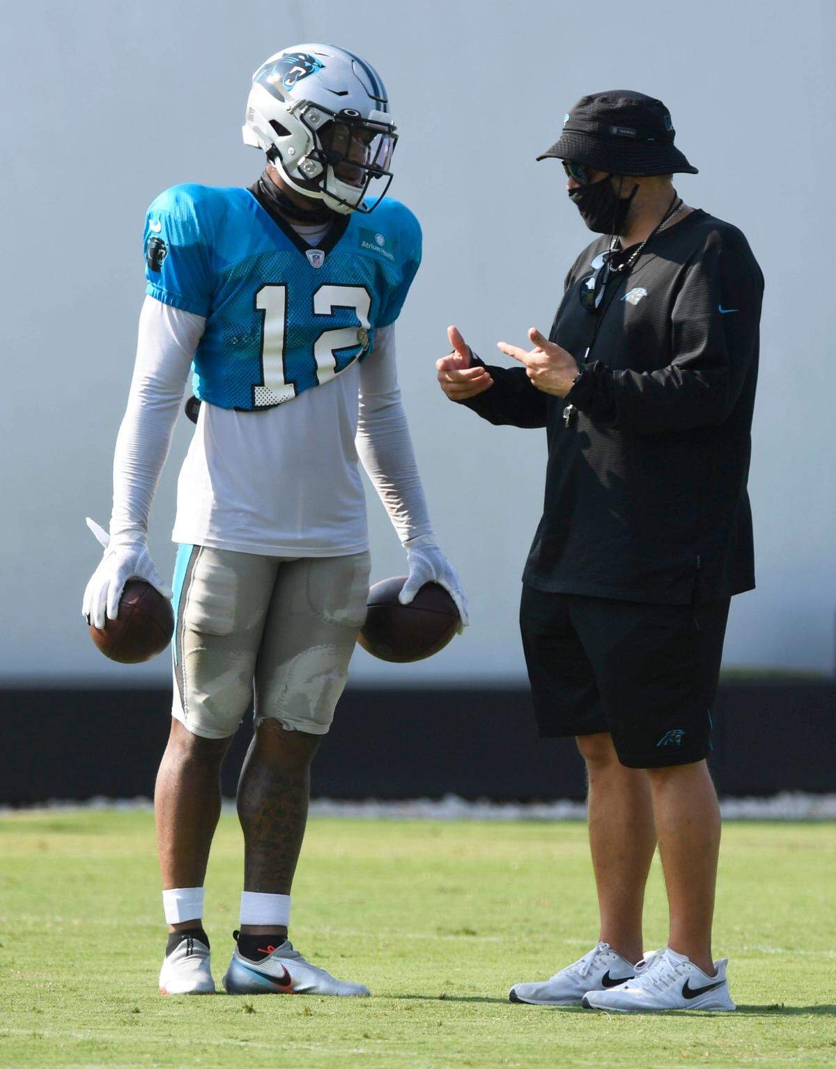 Carolina Panthers wide receiver DJ Moore (12) talks with head coach Matt Rhule during training camp at the team’s training facility on Monday, August 17, 2020.
