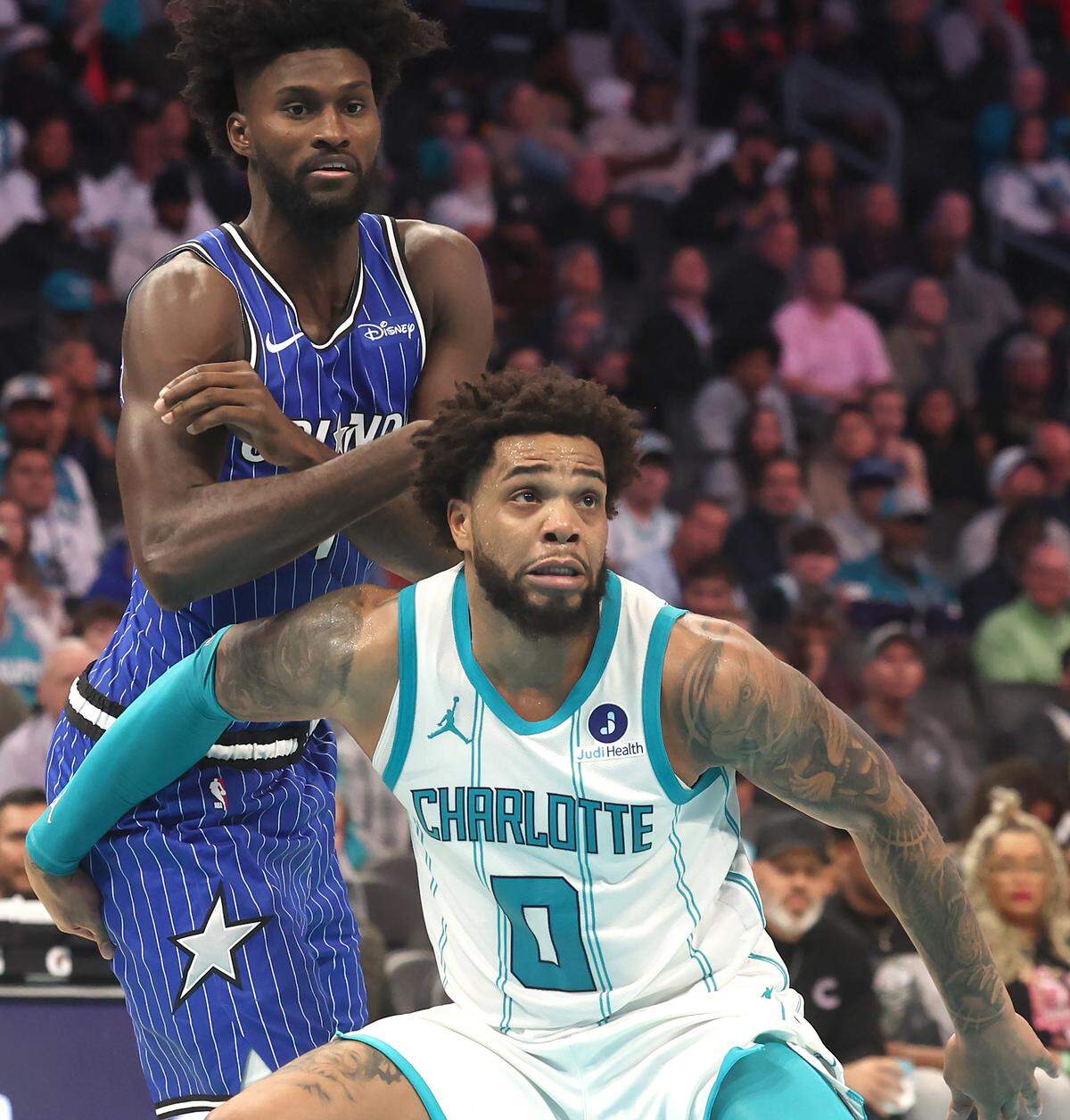 Charlotte Hornets forward Miles Bridges, front, blocks out Orlando Magic forward Jonathan Isaac, left, during action at Spectrum Center in Charlotte, NC on Thursday, October 30, 2025. The Magic defeated the Hornets 123-107.