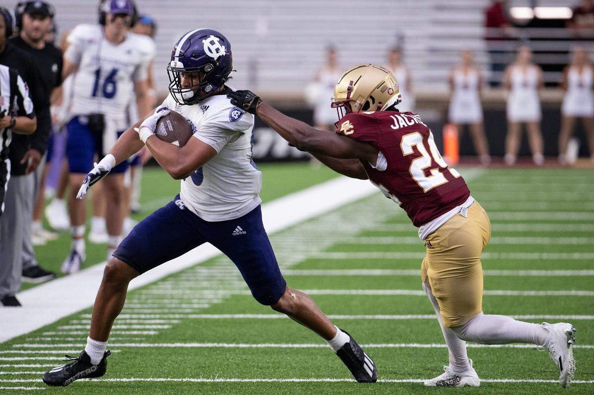 After play resumed Holy Cross's Jalen Coker runs out of bounds while Boston College's Amari Jackson pursues on Saturday September 9, 2023 at Alumni Stadium in Newton.