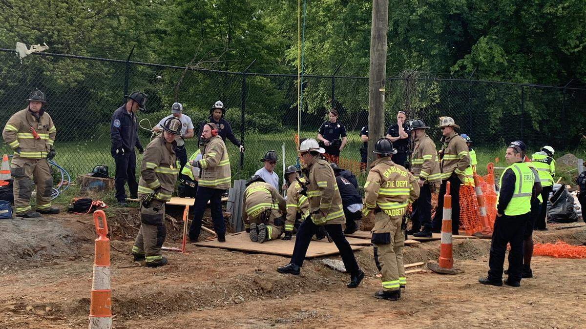 Charlotte Fire Department works to save someone who got stuck in a hole at a construction site.