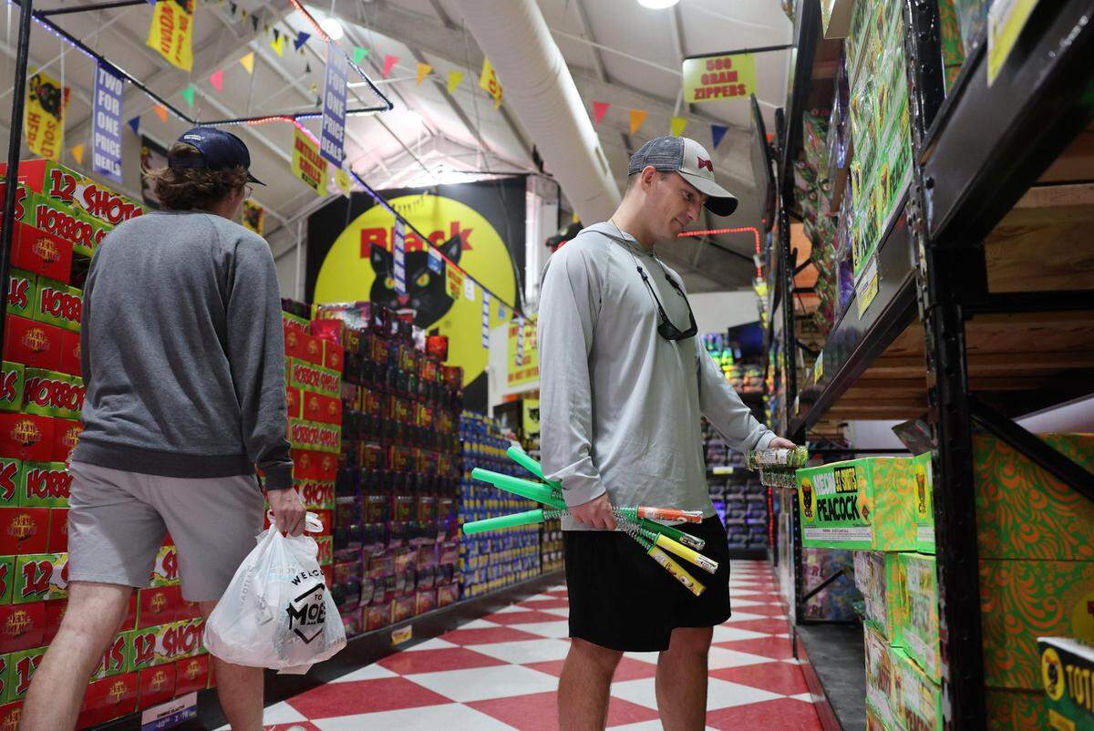 Oscar Joyner of Charlotte looks at the “Neon Peacock” fireworks Wednesday at Red Rocket Fireworks in Fort Mill.