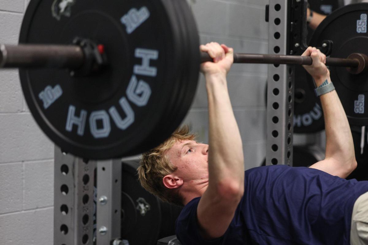 Tyler Baird, a baseball player at Hough High School, works out in the weightroom on Wednesday, February 12, 2025. Baird is one of the best players in the state and a major college recruit.