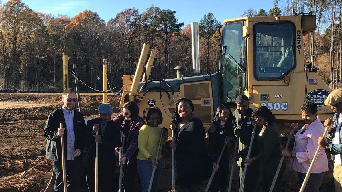 Members of the West Side Community Land Trust celebrate the groundbreaking for a new 120-unit senior affordable housing development along the West Boulevard corridor.
