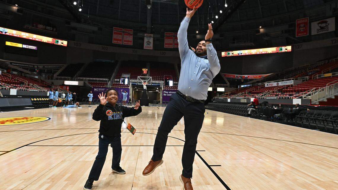 Joshua Sims Jr., 7 years old, left, smiles as he plays defense against his father, Joshua Sims Sr., right, prior to the Johnson C. Smith University vs Livingstone College women’s game at Bojangles Coliseum in Charlotte, NC on Thursday, March 20, 2025. The teams were competing in first day action of the Black College Invitational Championship (BCIC).