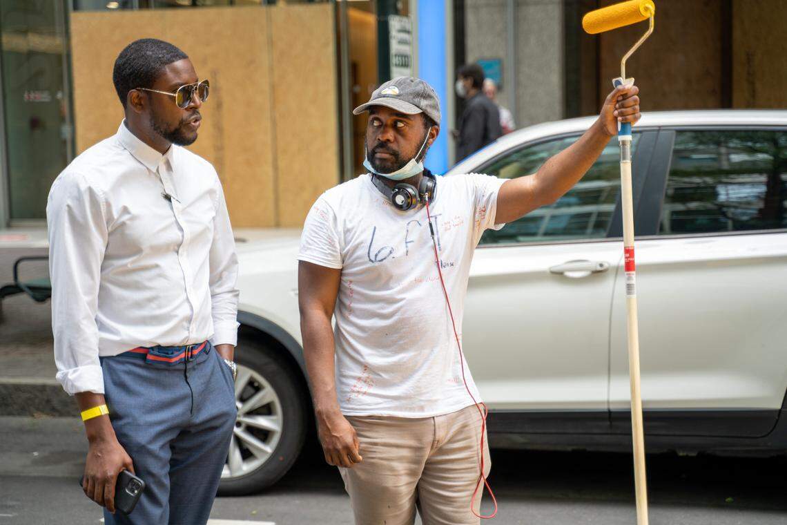Dammit Wesley, right, was among 17 artists who worked together to paint the Black Lives Matter mural on Tryon Street in Charlotte.