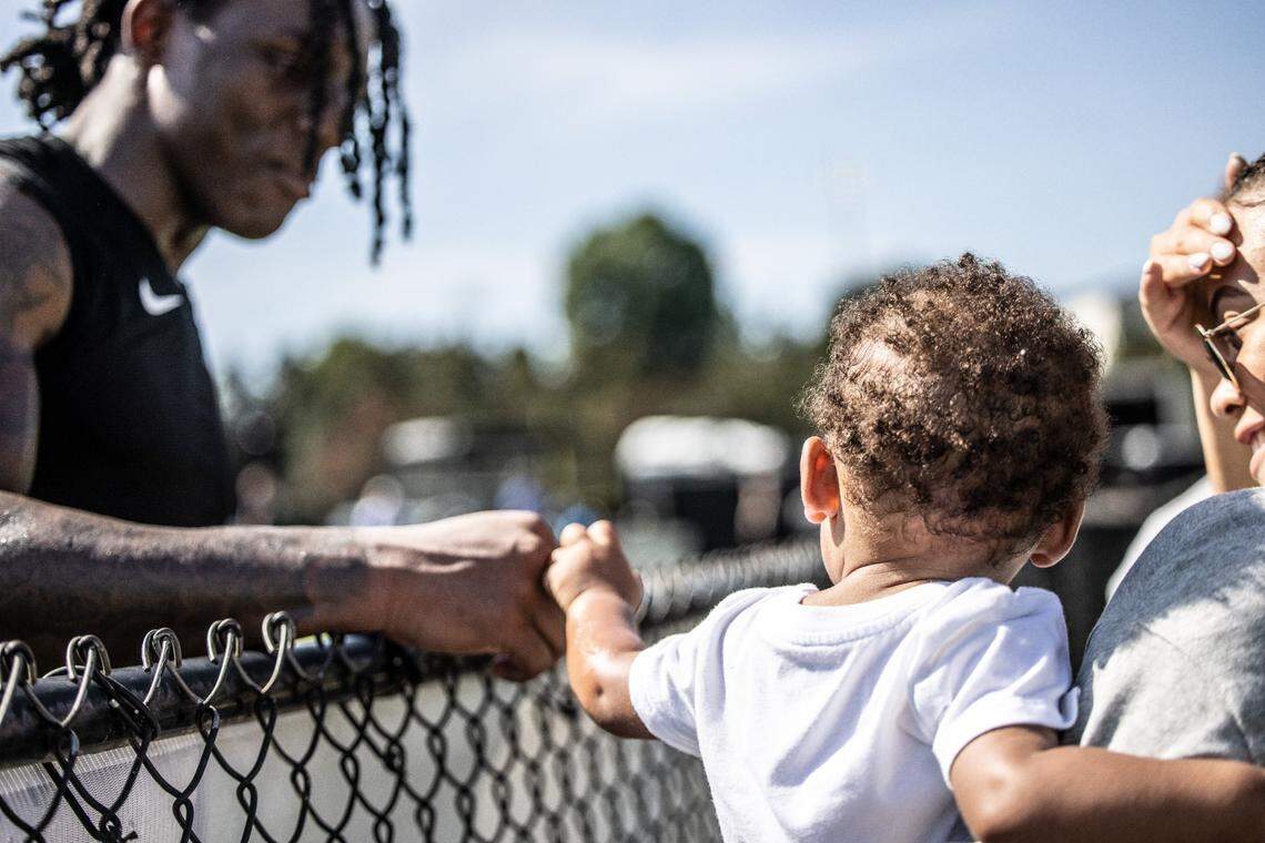 Carolina Panthers cornerback Jaycee Horn fist-bumps his nephew after an Aug. 19th practice.