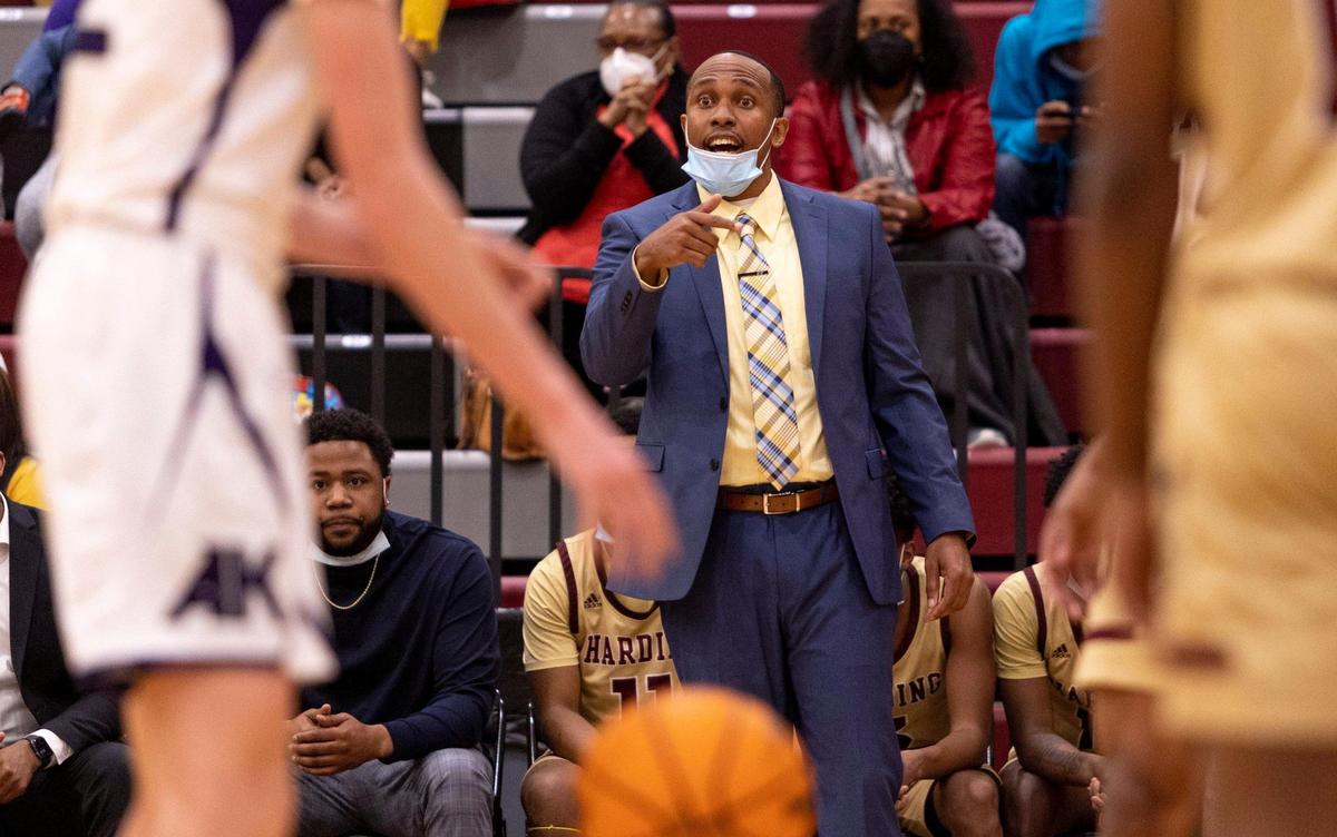 HardingÕs head coach LJ Johnson talks with his team during a free throw by Ardrey Kell at the SoMECK conference tournament championship game at Harding High School on Friday, February 18, 2022.