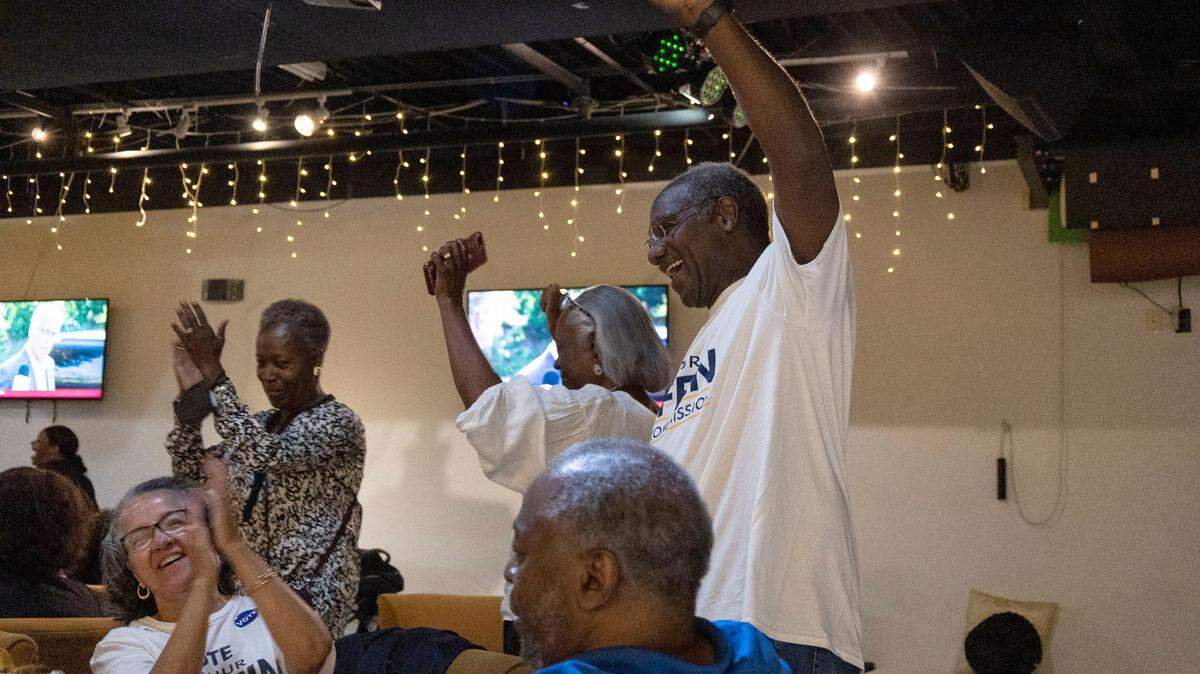 Arthur Griffin, right, Democratic at-large candidate for County Commissioner, enjoys himself after dancing the electric slide at the Black Political Caucus’ watch party at Studio 229 on Tuesday, May 17, 2022 in Charlotte.