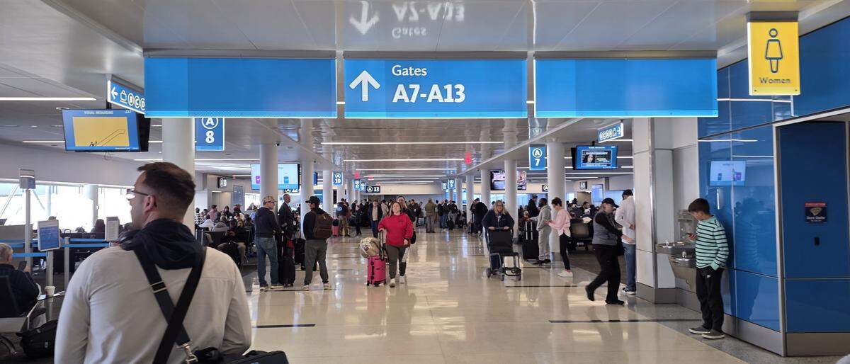 Passengers travel through Charlotte Douglas International Airport on Monday after Winter Storm Fern impacted the region over the weekend.