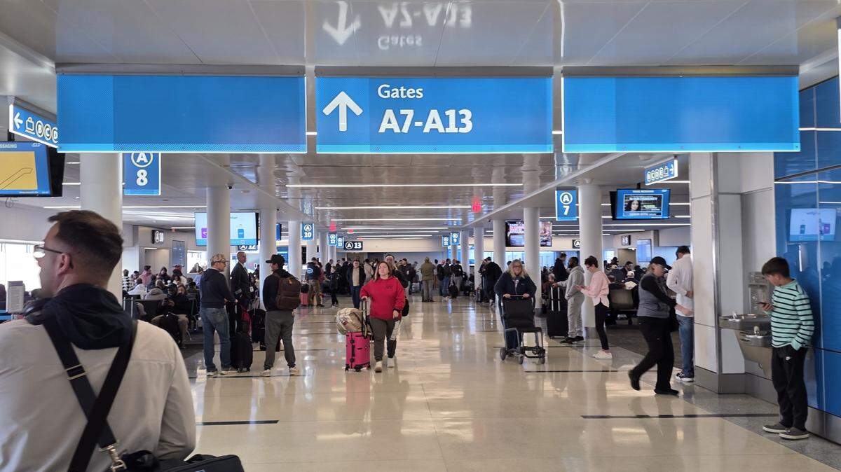 Fake FBI agent linked to a financial scam was arrested at Charlotte-Douglas International Airport, NC State Bureau of Investigation says.