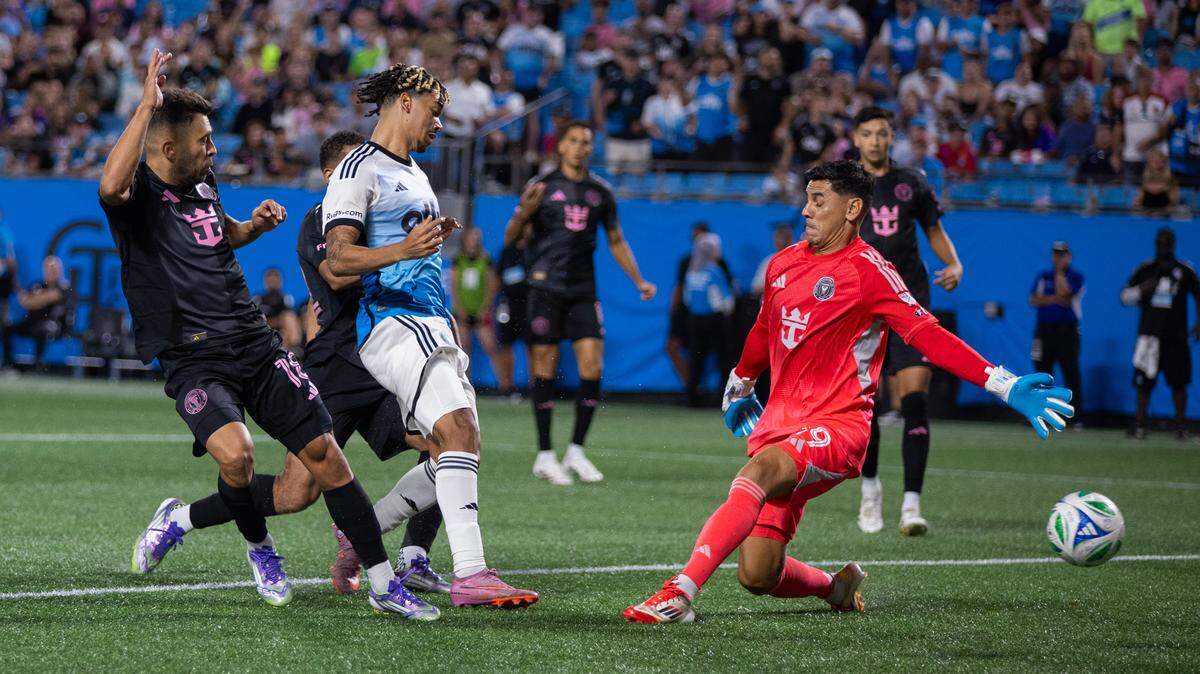 Sep 13, 2025; Charlotte, North Carolina, USA; Charlotte FC forward Idan Toklomati (17) shoots past Inter Miami goalkeeper Óscar Ustari (19) during the second half at Bank of America Stadium. Mandatory Credit: Scott Kinser-Imagn Images