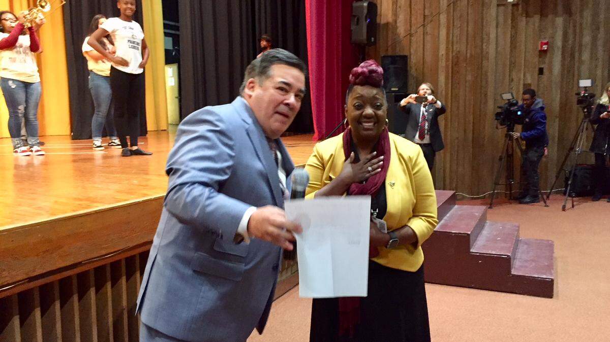 Superintendent Clayton Wilcox greets West Charlotte High Principal Timisha Barnes-Jones at a surprise announcement Tuesday that she is the Charlotte-Mecklenburg Schools 2018 principal of the year.