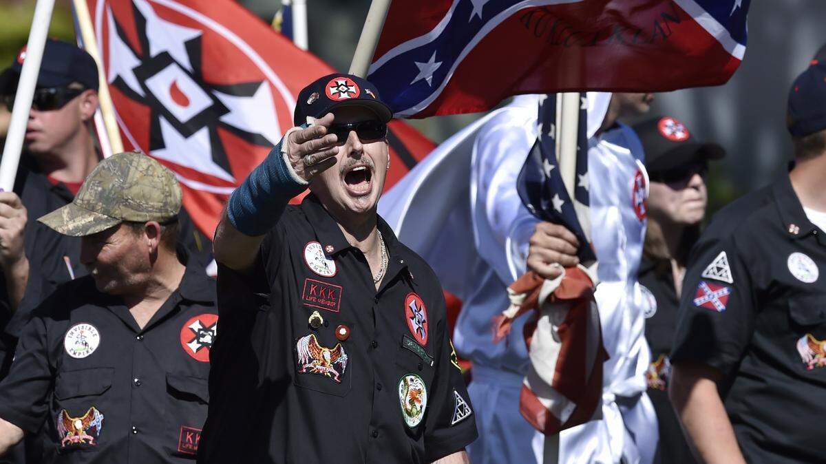 The Loyal White Knights of the Ku Klux Klan march in Rome, Ga., in this 2016 photo. A member of the Klan group says police and a judge in eastern North Carolina unfairly charged and convicted him of littering because he distributed Klan fliers.