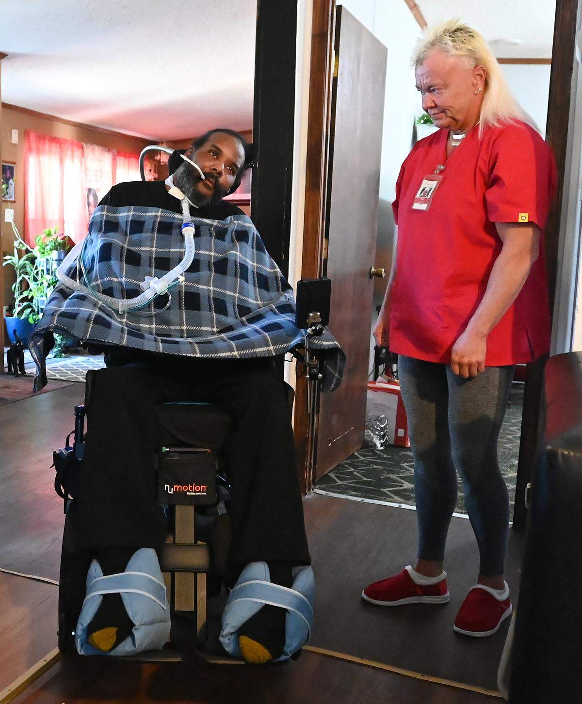 Sharod Knox, left, and his nurse Lou Eaton, right. Knox is a private duty nursing recipient with Hearts for Home Care. Knox sustained a life-altering gunshot wound in 2002 that resulted in quadriplegia and respiratory failure. 
