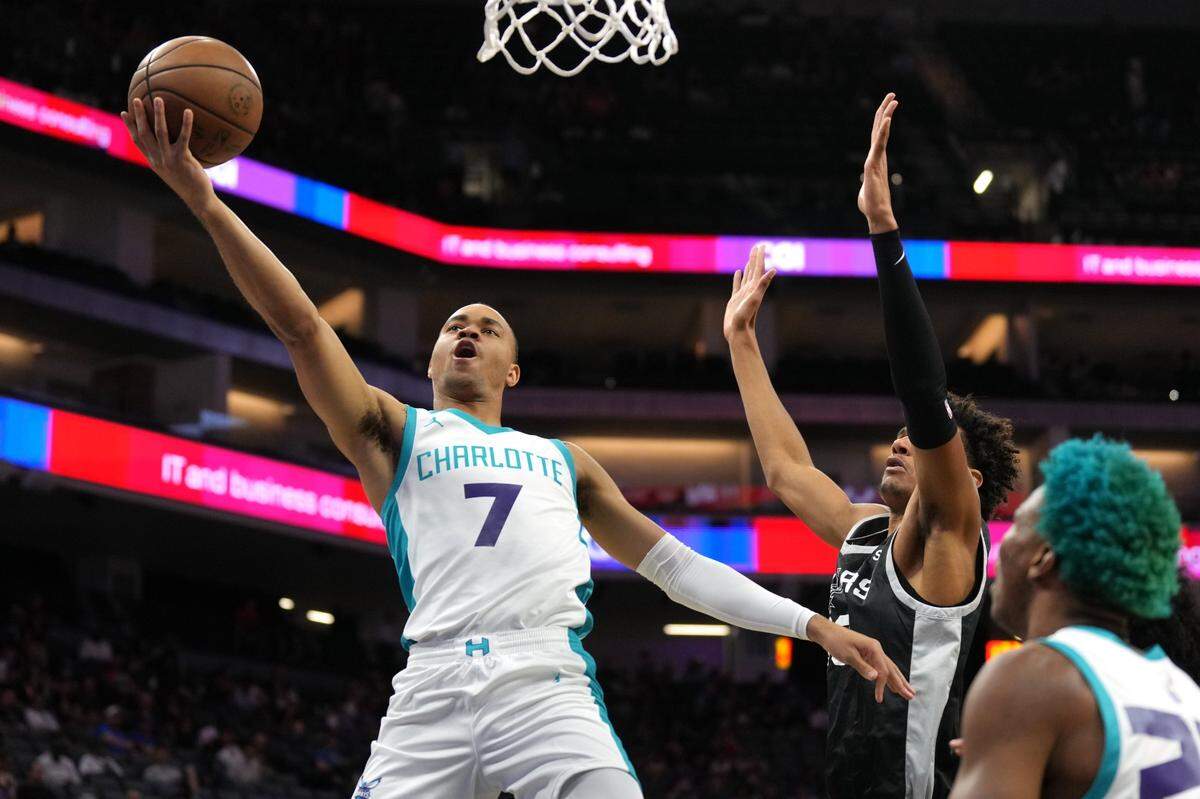 Charlotte Hornets guard Bryce McGowens (7) shoots against San Antonio Spurs forward Dominick Barlow (right) during the first quarter of a summer league game at Golden 1 Center on July 3, 2023.