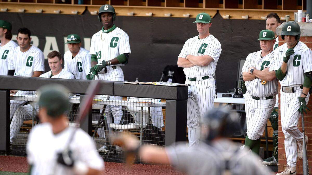 Charlotte 49ers head coach Robert Woodard, center, watches his team battle UNCW on Thursday, May 20, 2021. The 49ers are having the best season in school history and may host NCAA tournament games.