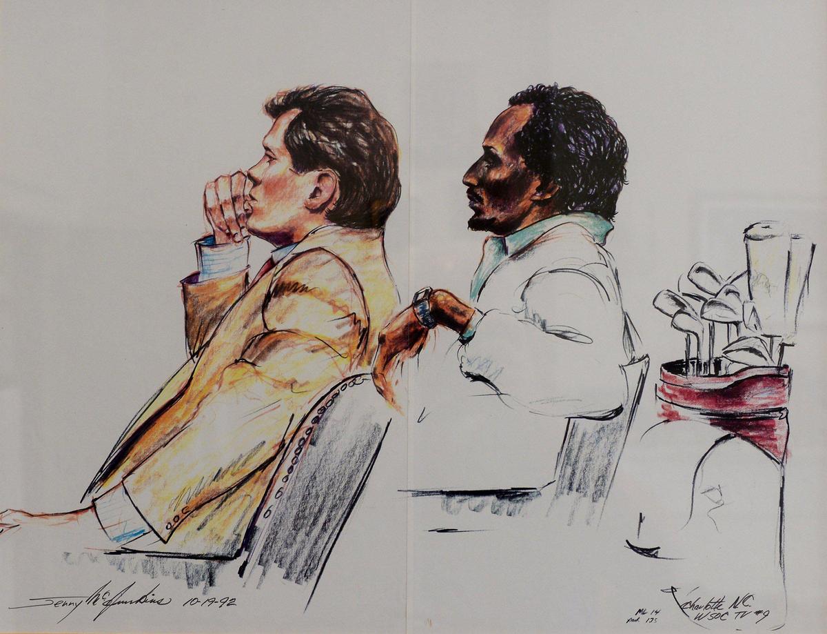 Charlotte lawyer James Wyatt, left and his client James “Slim” Bouler, right, sit in a federal courtroom in 1992. NBA star Michael Jordan became implicated with Bouler through checks from golf gambling debts totaling $57,000.