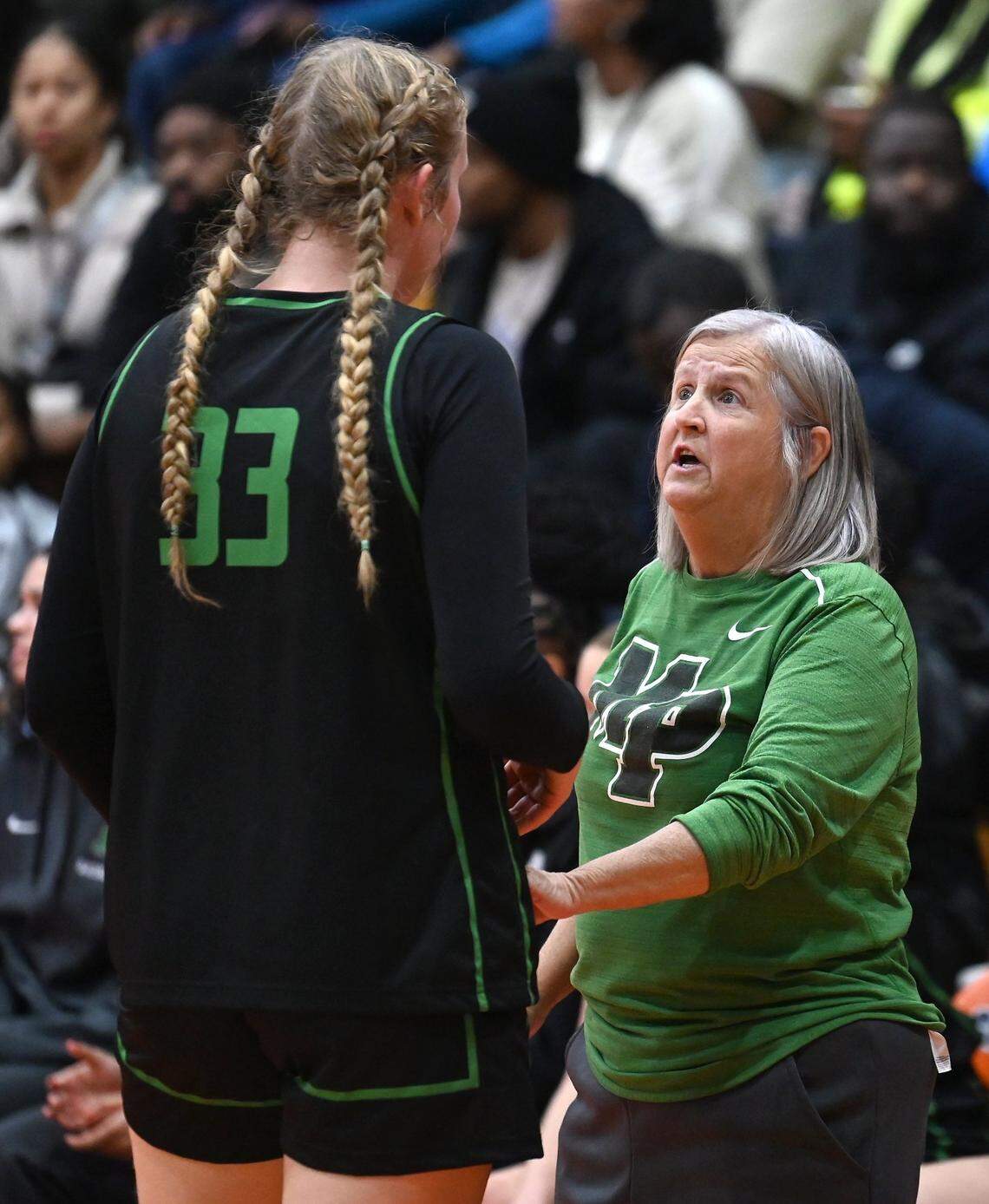 Myers Park’s Evelyn Jimenez-Willis, left, receives instructions from head coach Barbara Nelson, right, during prep action against Chambers High on Tuesday, November 28, 2023.