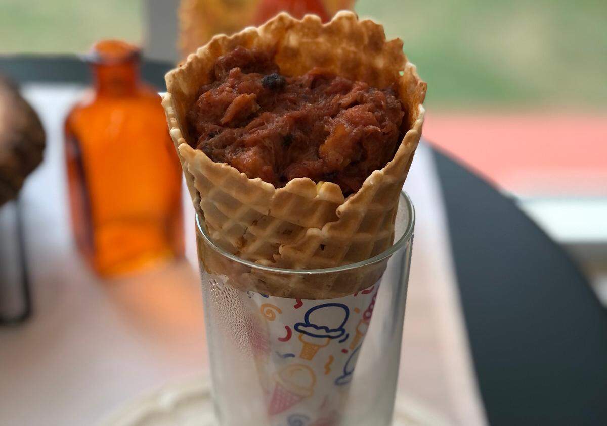 Mac and cheese and pulled pork in a waffle cone