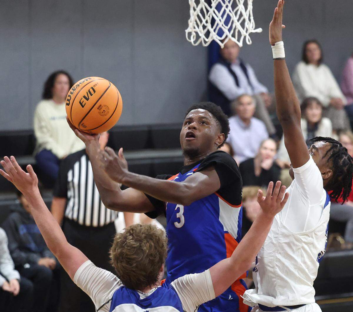 Lake Norman Christian’s Isaiah Frierson, center, drives to the basket during action against Charlotte Christian on Tuesday, November 12, 2024.