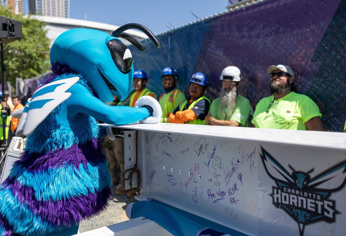 Hugo the Hornet signs the beam during the Hornets' ceremonial Topping Off Ceremony at Novant Health Performance Center's construction site, celebrating a major milestone, the placement of the building's final structural beam in Charlotte, N.C., on Monday, May 4, 2026.