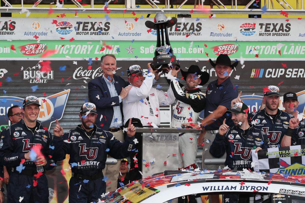 NASCAR Cup Series driver William Byron (24) and team owner Rick Hendrick host the trophy after winning the AutoTrader EcoPark Automotive 400 at Texas Motor Speedway.