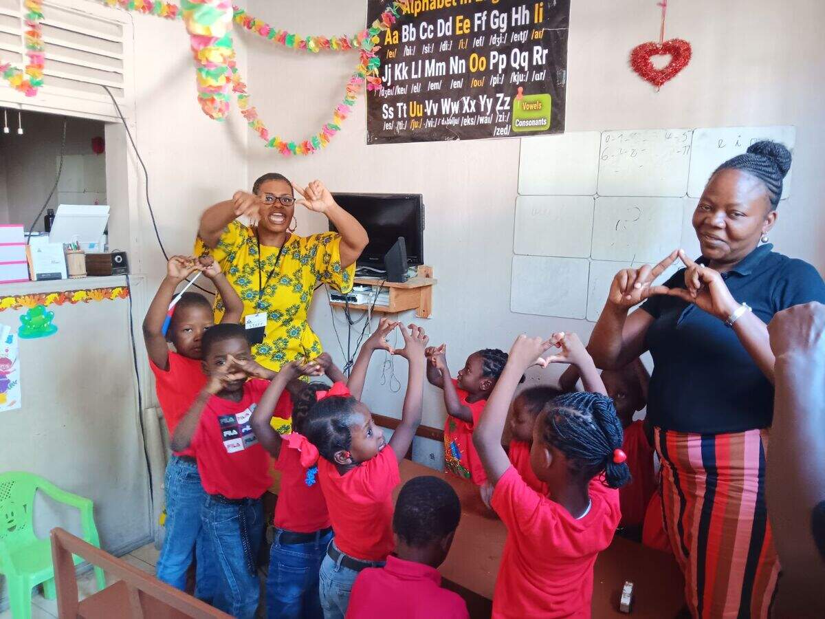 Lynn Phanor of Charlotte, back left, with children and a teacher at the school she founded in Haiti, Jeune Doit Vivre Kindergarten.