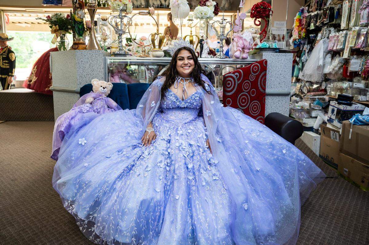 Daniela Robledo smiles at the fitting for her quinceañera dress at Yolanda's Creations on Central Avenue in Charlotte. Robledo spent her youth watching shows about young Latina women having their quinceañera and dreaming about her own. When she approached her 16th birthday, her parents asked if she would like a car or a quinceañera. She chose the latter. 