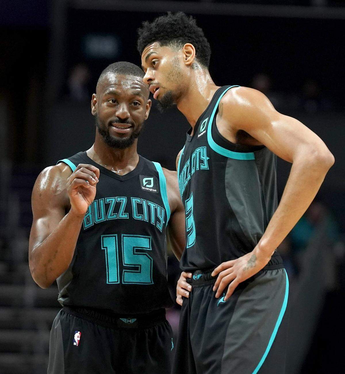 Charlotte Hornets guards Kemba Walker, left and Jeremy Lamb, right, talk during first half action against the Toronto Raptors at Spectrum Center in Charlotte, NC on Friday, April 5, 2019.