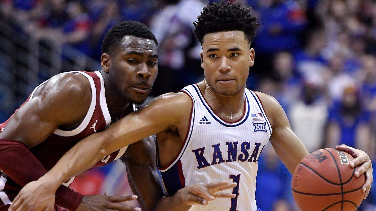 KU’s Devon Dotson (1) drives on OU’s De’Vion Harmon during the second half of Saturday’s game at Allen Fieldhouse. KU beat Oklahoma, 87-70.
