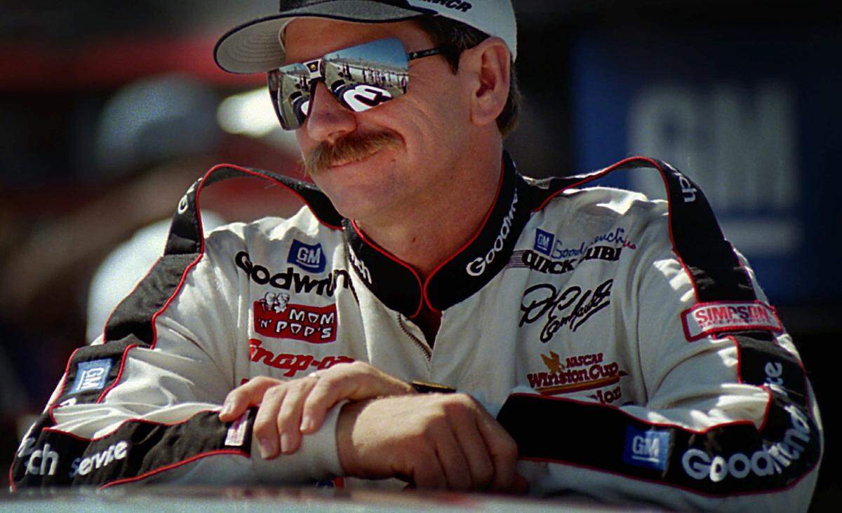 Seven-time Winston Cup champion Dale Earnhardt leans on the roof of his Chevrolet Monte Carlo in Sept. 29, 1995.